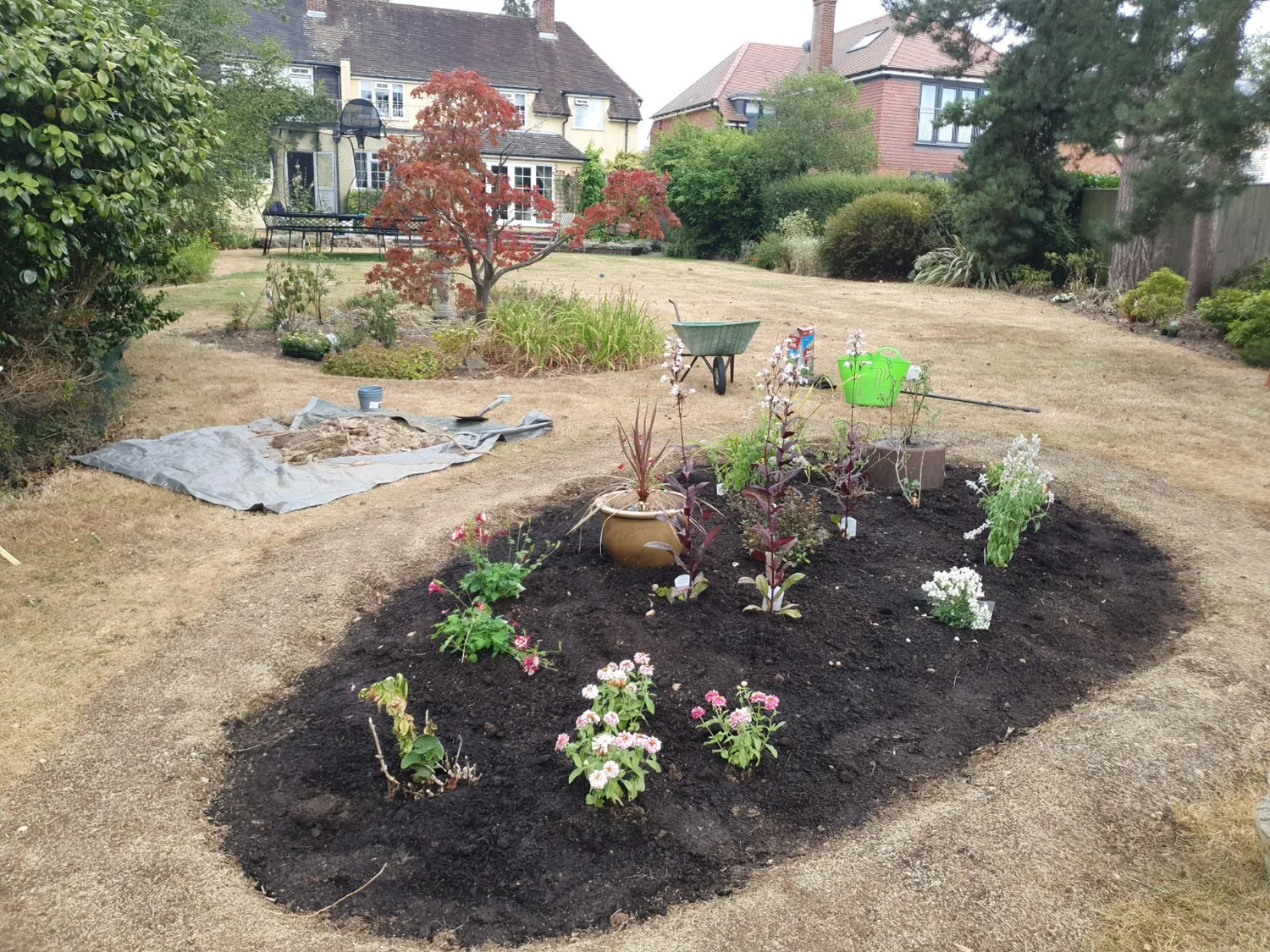 Freshly created planting bed in a lawn